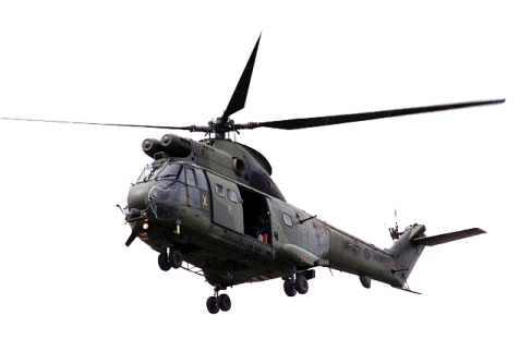 a military helicopter flying through the air