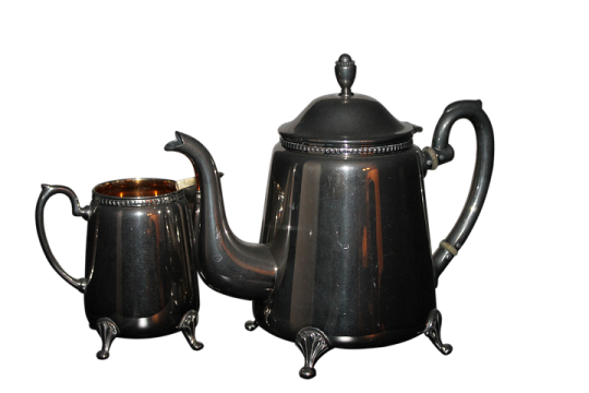 a black coffee pot and a silver teapot