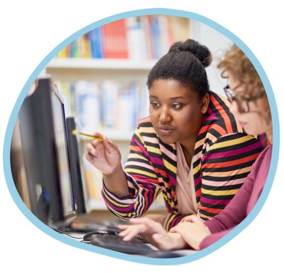 a woman sitting in front of a computer