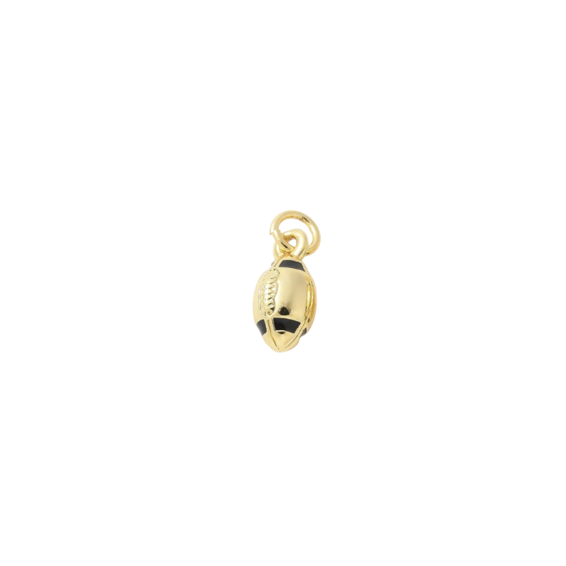 a gold plated charm with a black and white bea