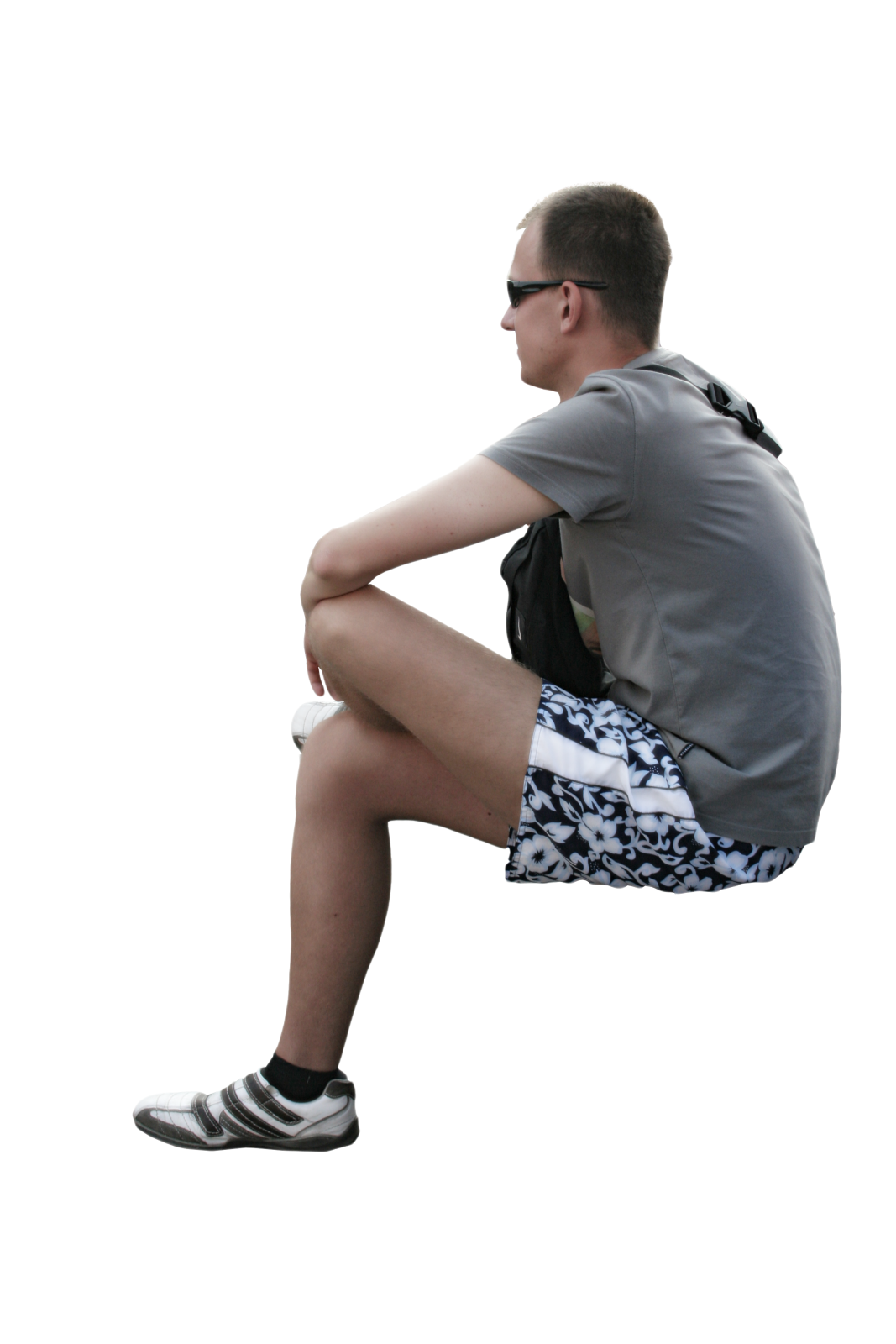 a man sitting on the ground with his legs crossed