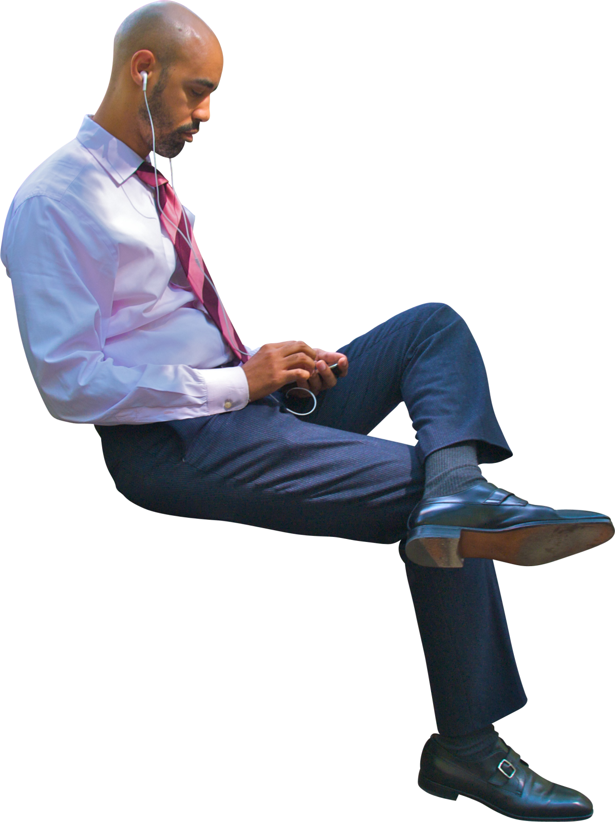 a man sitting on a chair using his cell