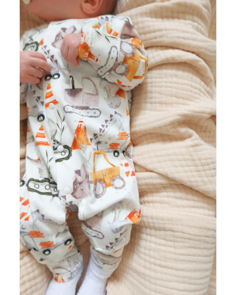 a baby laying on top of a blanket