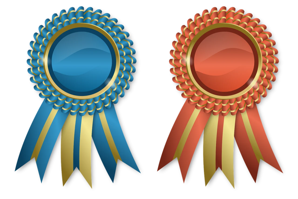 three medals with ribbons on them