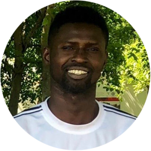 a man in a white shirt smiles at the camera