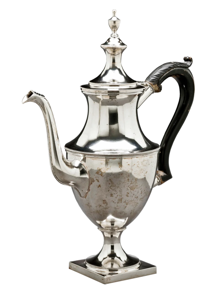 an antique silver coffee pot on a stand