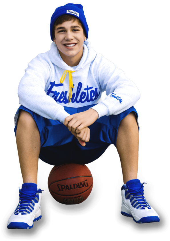 a young boy sitting on a basketball ball