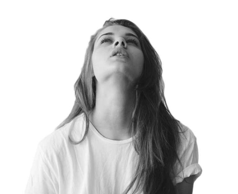 a woman with long hair and white shirt looking up at the sky