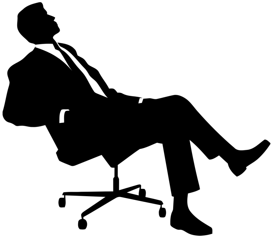 a silhouette of a man sitting in an office chair