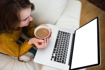 a woman sitting on a couch holding a cup of coffee