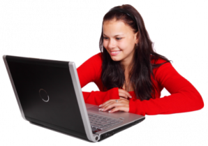 a woman sitting at a table with a laptop