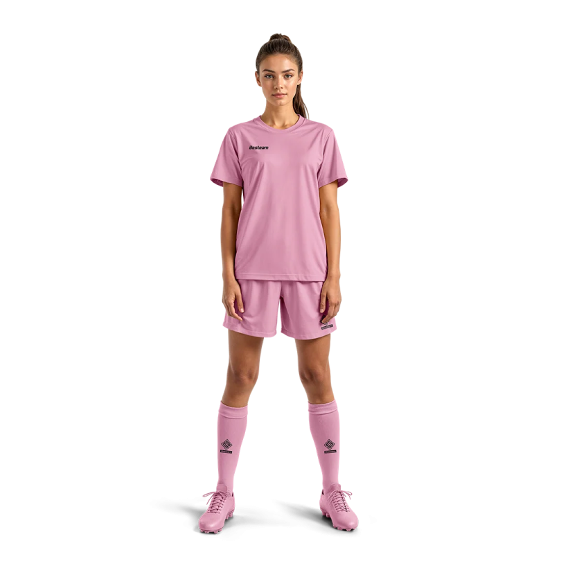 a young girl in pink soccer jersey and shorts