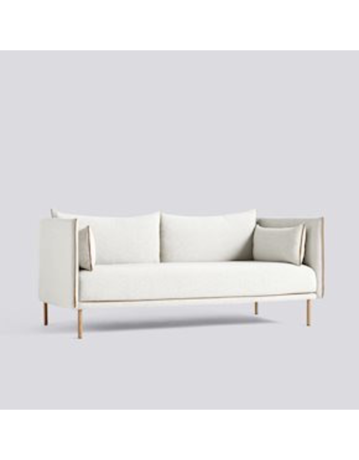 a white couch with two pillows on it