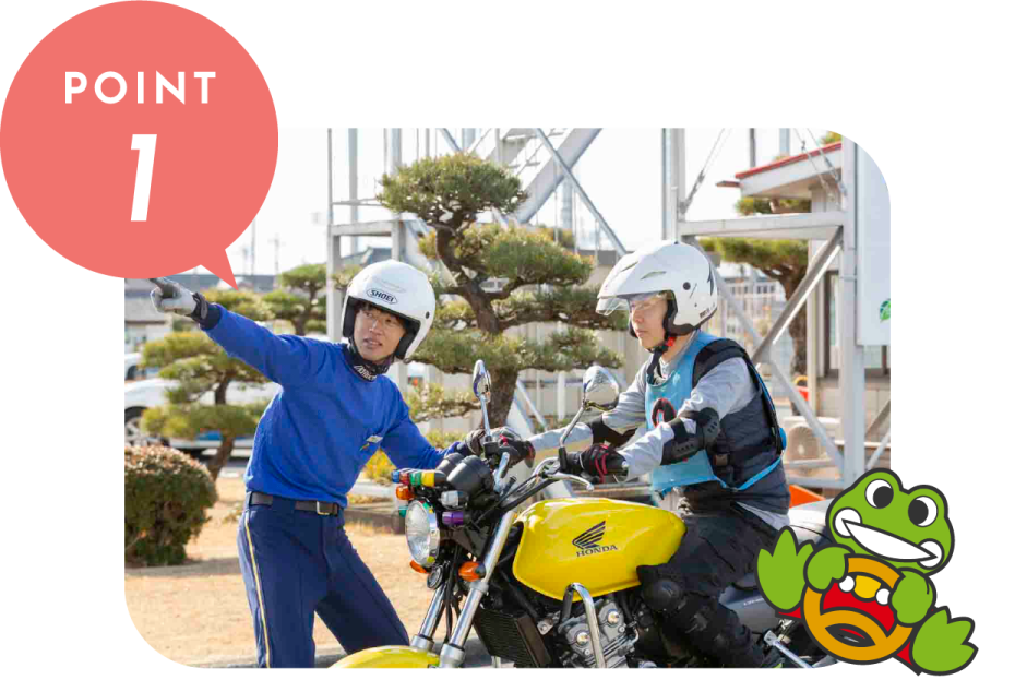 two people on a motorcycle in front of a building