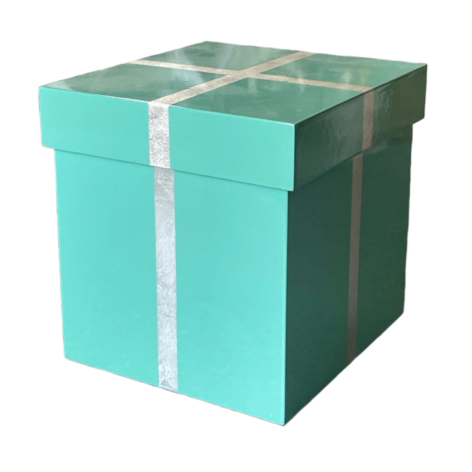 a green gift box with a silver ribbon