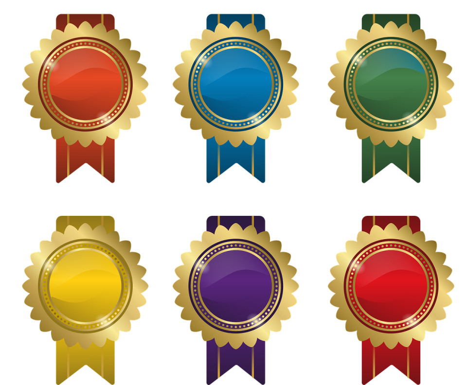 a set of four gold, red and blue award ribbons