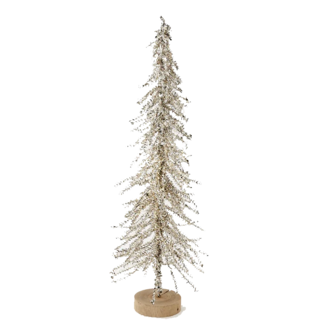a white christmas tree on a wooden base