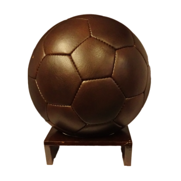 a brown soccer ball on a wooden stand