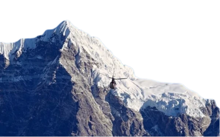 a helicopter flying over the top of a mountain