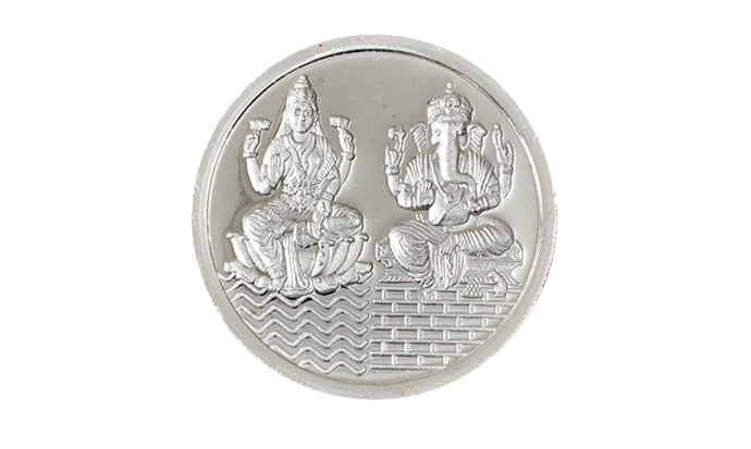 a silver coin with the image of buddhas on it