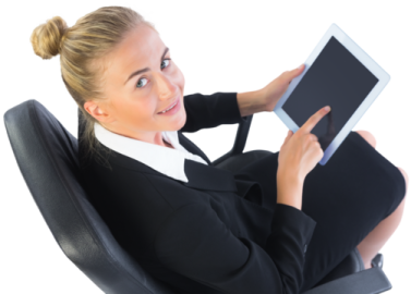 a woman sitting in an office chair holding a tablet