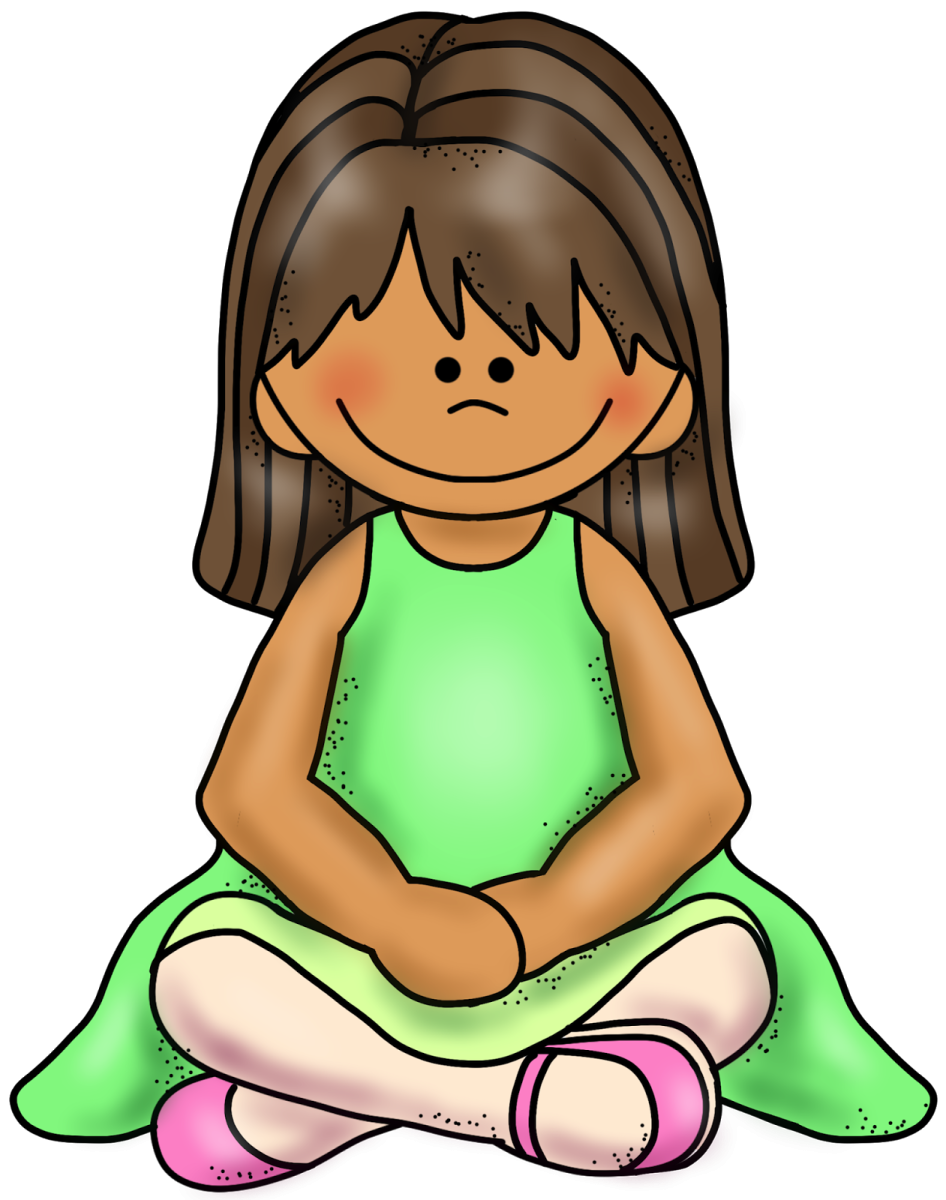 a little girl sitting on the floor with her legs crossed