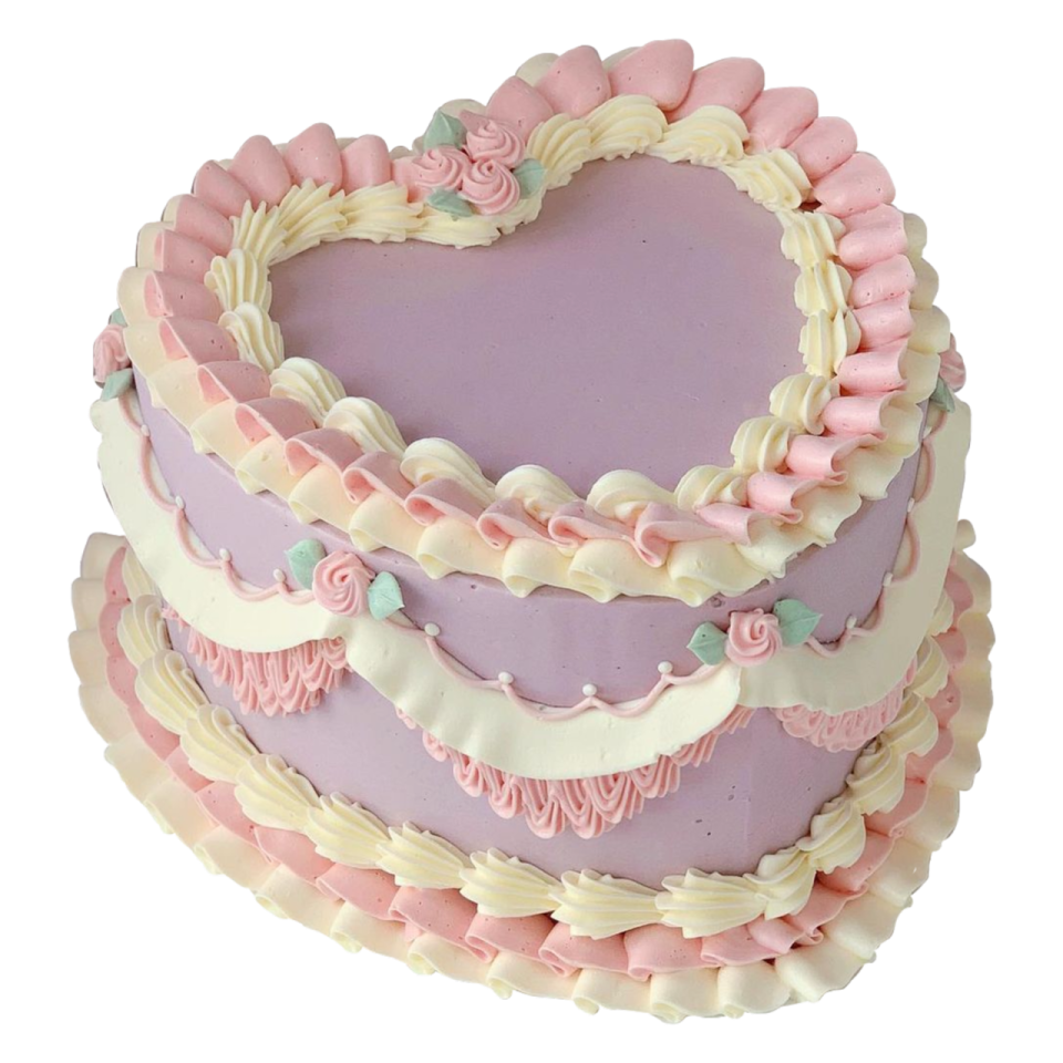 a heart shaped cake with pink and white frosting