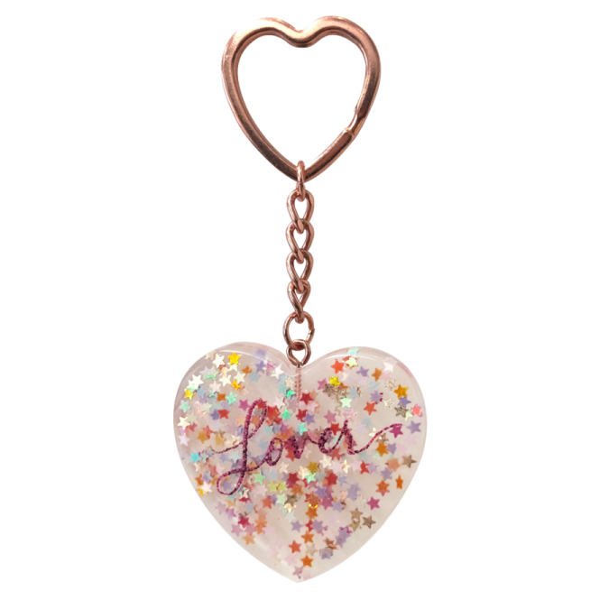 a heart shaped keychai with the word love written on it