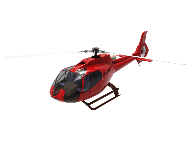 a red helicopter is flying in the air
