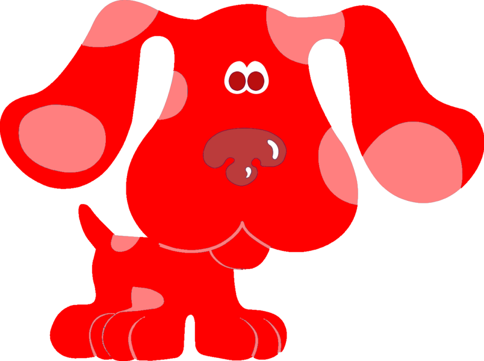 a red dog sitting down on the ground