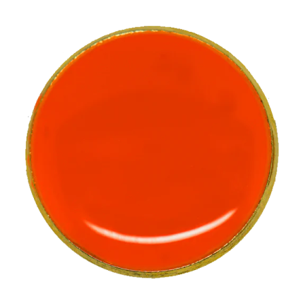 a red button with gold trim