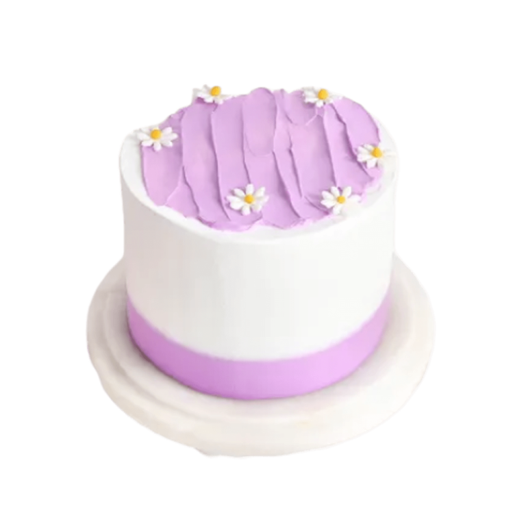 a white and purple cake with flowers on top