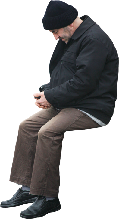 a man sitting on a bench using his cell