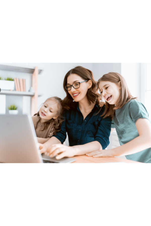 a woman and two young girls looking at a laptop