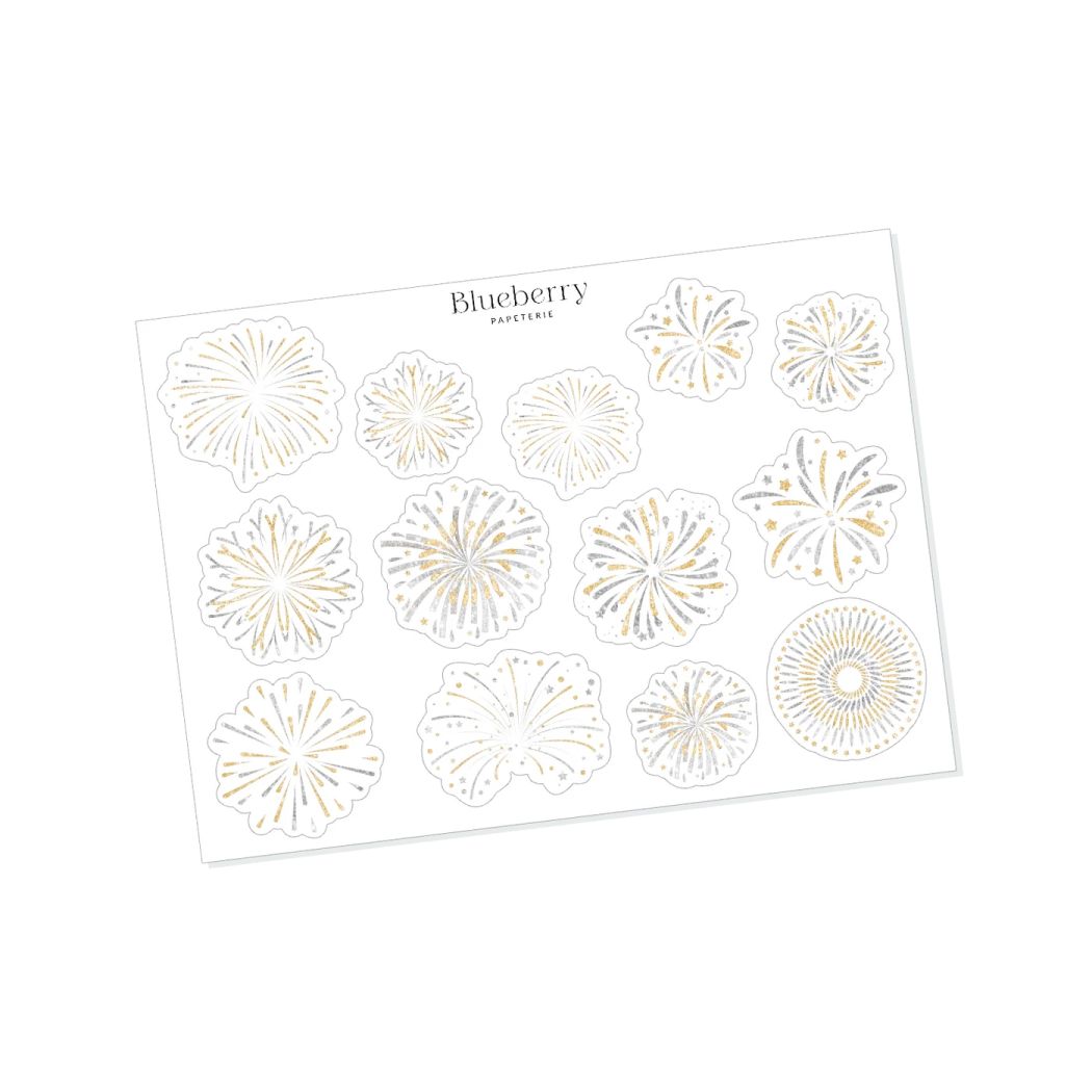 a white card with gold foil flowers on it