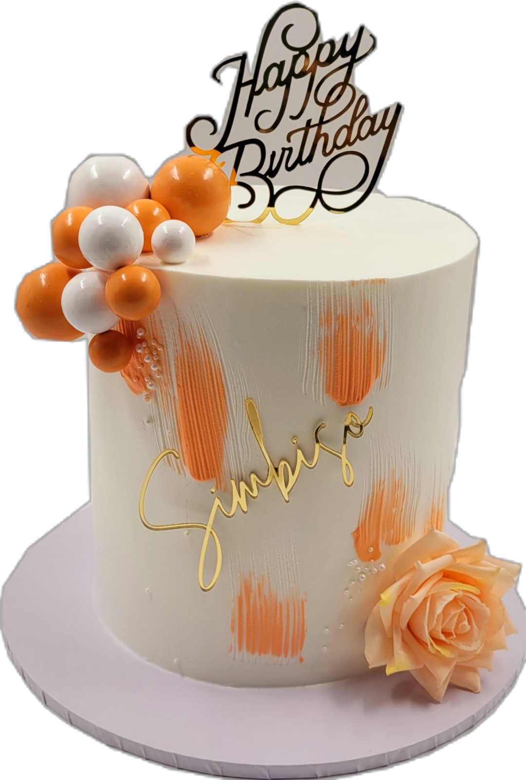 a white cake with orange and gold decorations