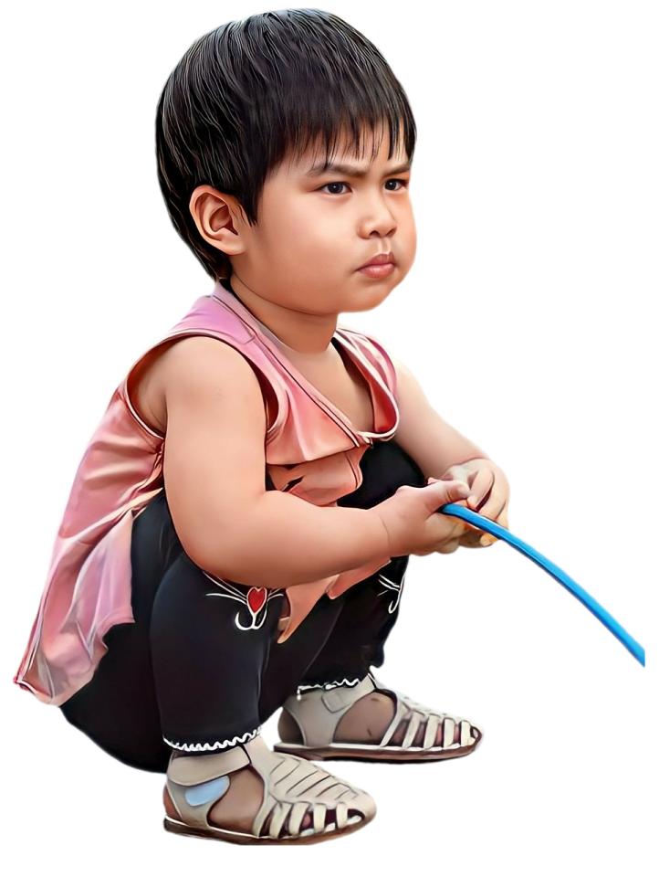a small child sitting on the ground with a toothbrush
