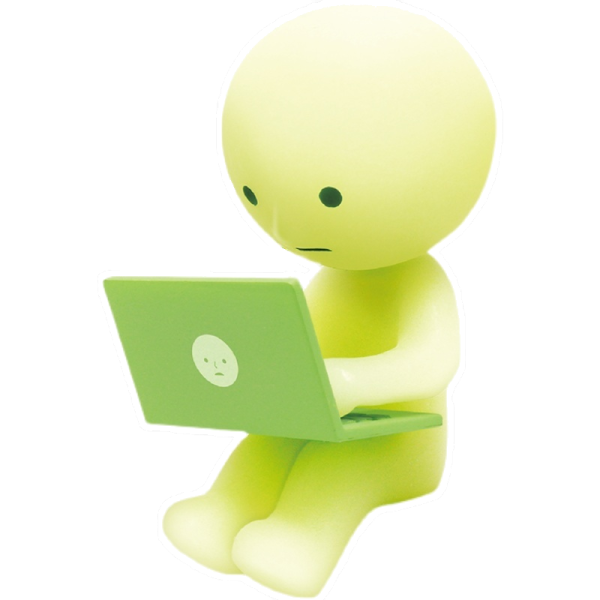 a small figure sitting on top of a laptop