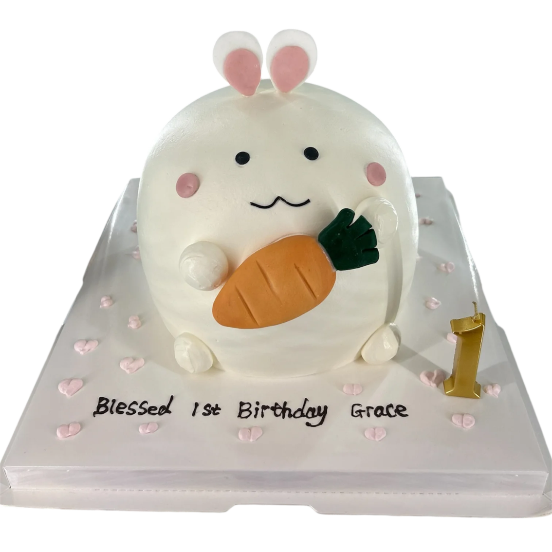 a birthday cake with a white bunny holding a carrot