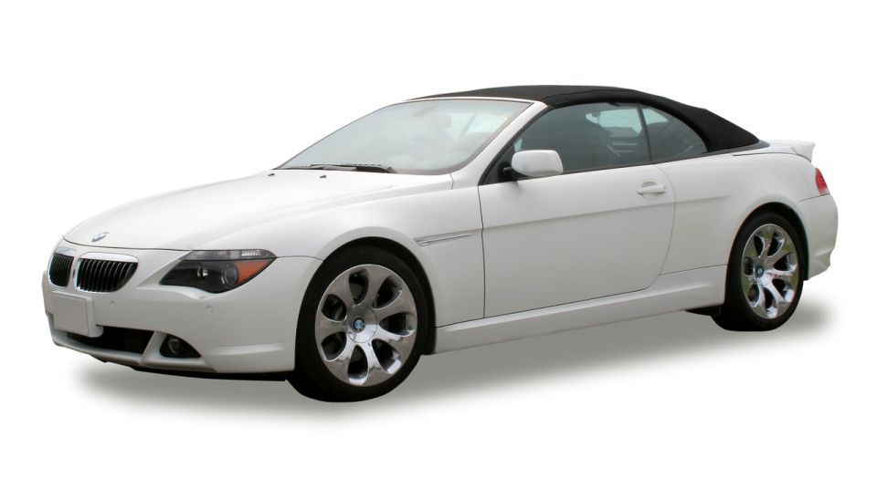 a white bmw convertible with a black top