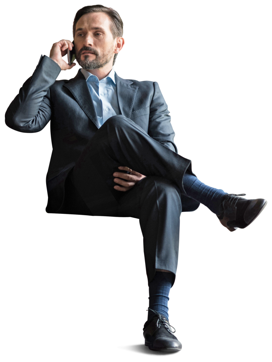 a man in a suit and tie sitting on a chair
