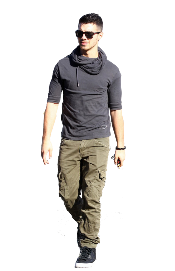 a man walking down the street wearing cargo pants