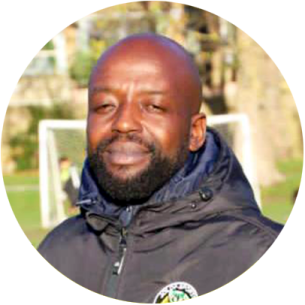 a man in a black jacket is smiling at the camera