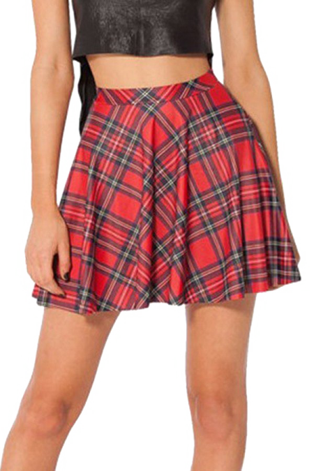 a woman wearing a black top and red plaid skirt