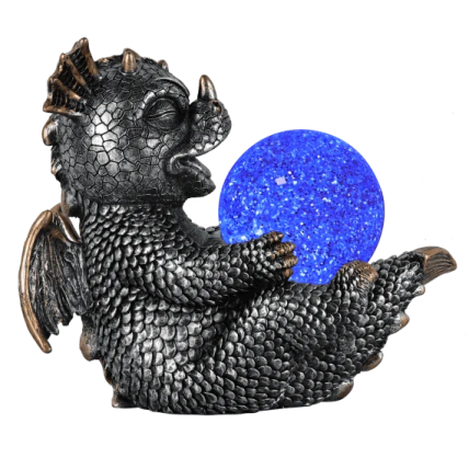 a black dragon holding a blue crystal ball