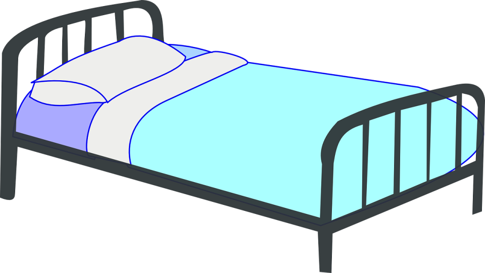 a bed with blue sheets and pillows