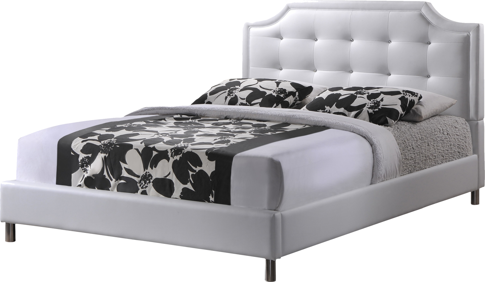 a white bed with black and white pillows