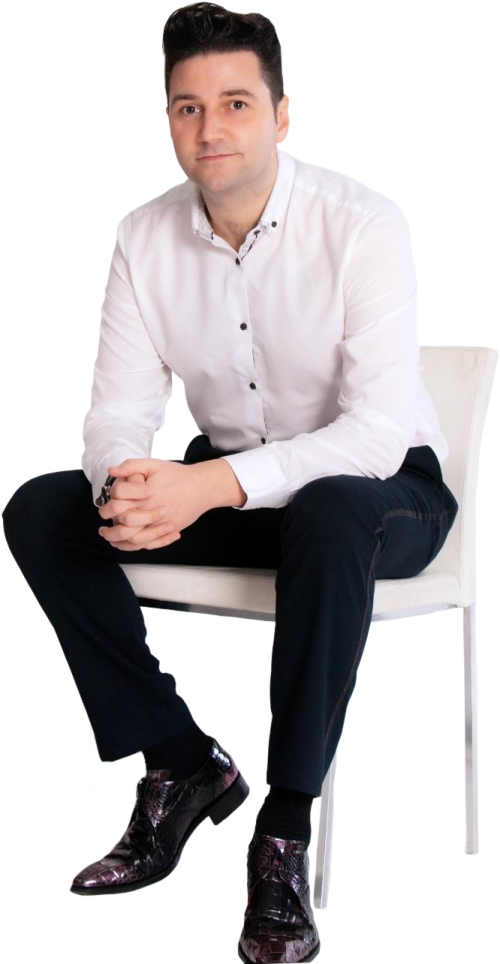 a man in a white shirt sitting on a chair