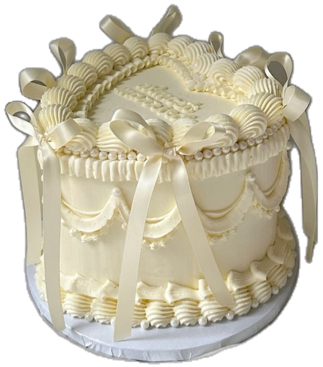 a cake with white frosting and bows