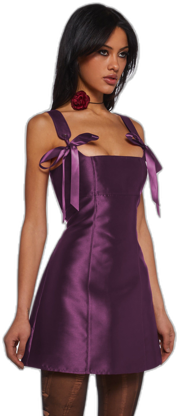 a woman wearing a purple dress with a bow